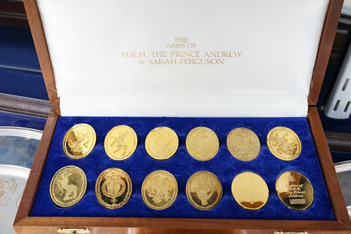 Two framed Elizabeth II parcel gilt silver commemorative plates, 'The College of Arms Silver Jubilee and Coronation', maker YM, London, 1977/78, with certificates, together with a cased set twelve oval silver gilt ingots